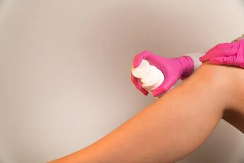 Apply moisturizer on the legs until depilation shugaring Stock Photos