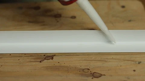 Apply mounting adhesive to the plastic corner. Sealant and plastic corner. Stock Footage 129411027