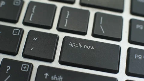 Apply now button on computer keyboard, female hand fingers press key Stock Footage 97828256