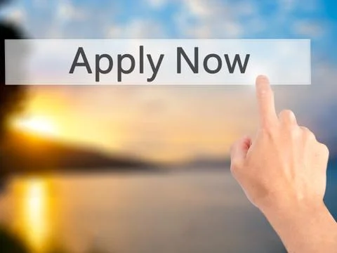 Apply Now - Hand pressing a button on blurred background concept on visual sc Stock Photos