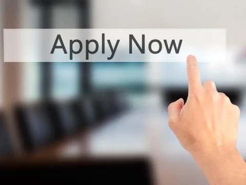 Apply Now - Hand pressing a button on blurred background concept on visual sc Stock Photos