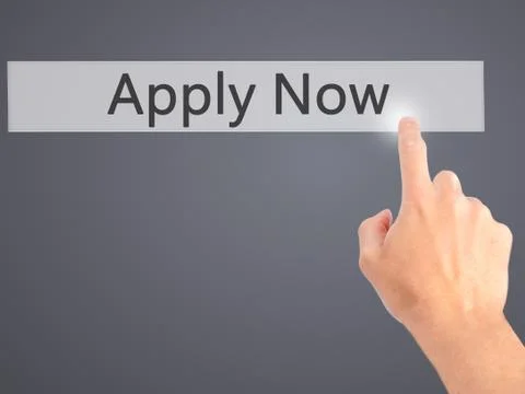 Apply Now - Hand pressing a button on blurred background concept on visual sc Stock Photos