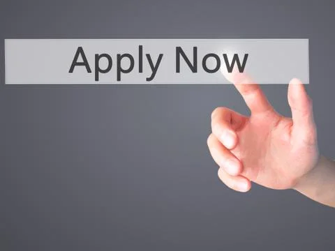Apply Now - Hand pressing a button on blurred background concept on visual sc Stock Photos