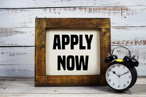 Apply  Now text with alarm clock on wooden background Stock Photos