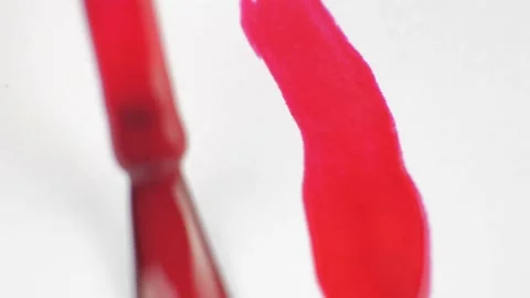 Apply red varnish on a white background Video stock 218629450