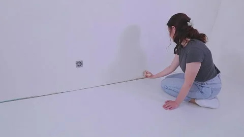 Apply wallpaper paste to the wall with a roller or brush. Applying wallpaper Stock Footage 332245887