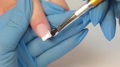Applying acrylic nail Stock Footage 81061101