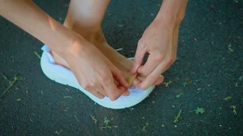 Applying adhesive bandage on blistered toe after walking or running outdoors Video stock 336108656