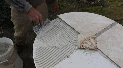 Applying adhesive solution to the surface to fix tiles Stock Photos