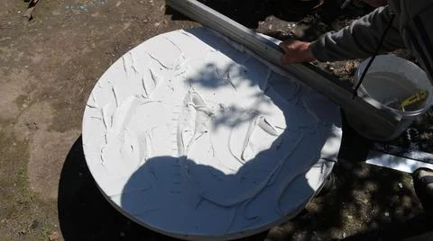 Applying and leveling the mortar on a round tabletop Stock Photos