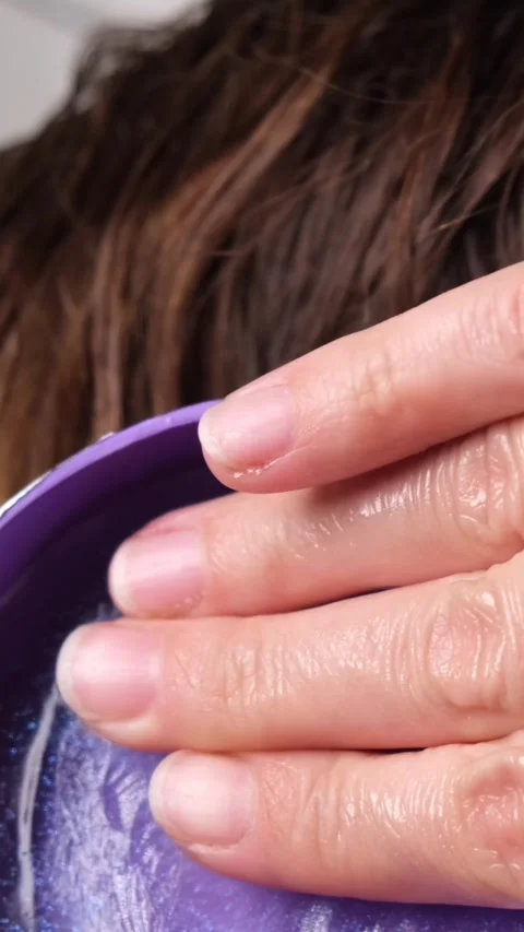 Applying and pre-warming the styling wax in your fingers or palms Stock Footage 311769184