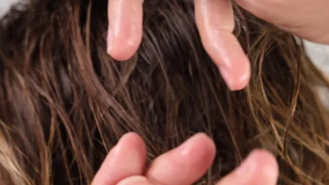 Applying and pre-warming the styling wax in your fingers or palms Stock Footage 311795231