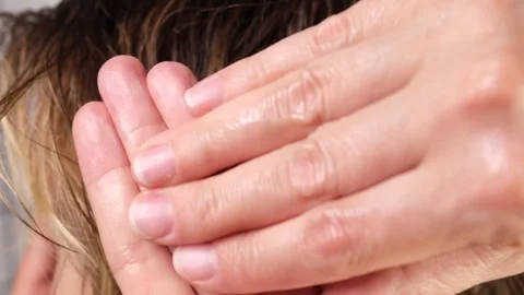 Applying and pre-warming the styling wax in your fingers or palms Stock Footage 311972877