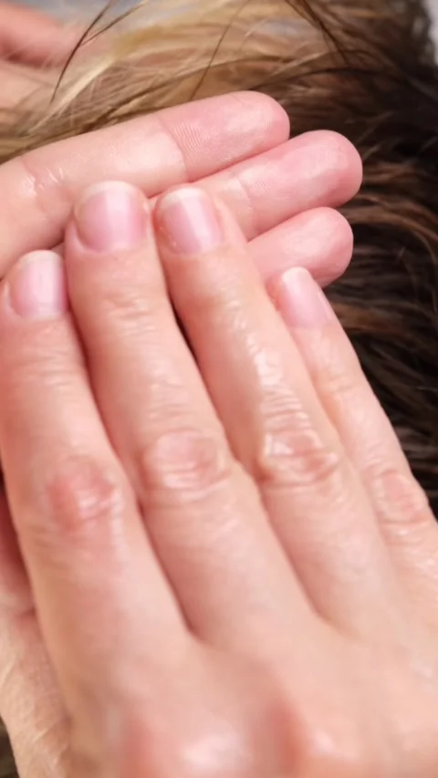 Applying and pre-warming the styling wax for hair in your fingers or palms Stock Footage 312062410