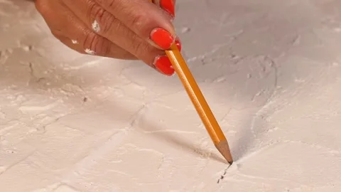Applying an artistic white textured plaster with a small metal palette knife Stock Footage 135751505