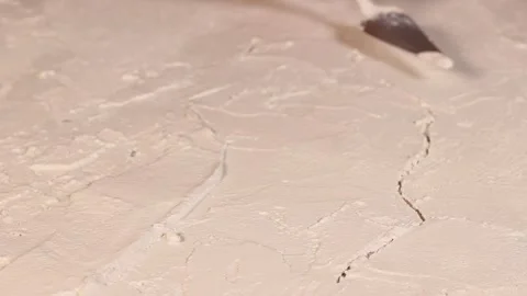 Applying an artistic white textured plaster with a small metal palette knife Stock Footage 135751535
