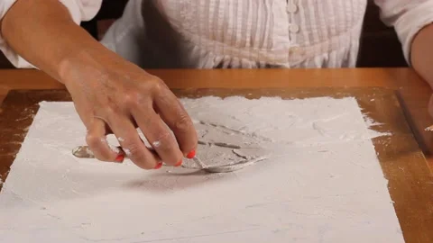 Applying an artistic white textured plaster with a small metal palette knife Stock Footage 135751579