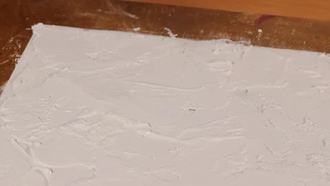 Applying an artistic white textured plaster with a small metal palette knife Stock Footage 135751637