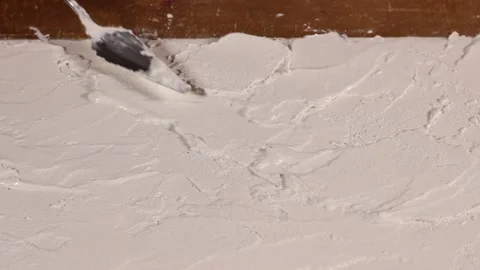 Applying an artistic white textured plaster with a small metal palette knife Stock Footage 135751678
