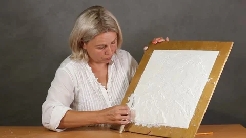 Applying an artistic white textured plaster with a small metal palette knife Stock Footage 135752190