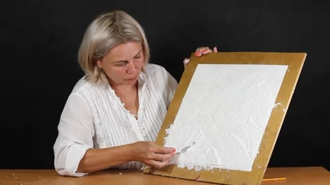 Applying an artistic white textured plaster with a small metal palette knife Stock Footage 135752383