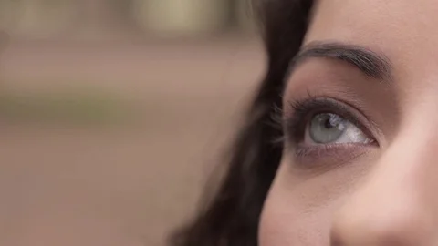 Applying base on brunette's eye,close up Stock Footage 74715426