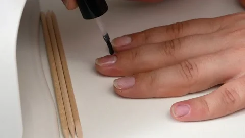 Applying the base of the nail.Drying in a UV lamp with LEDs. Stock Footage 133565853