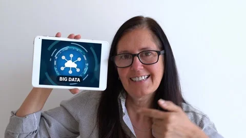 Applying big data to your business and your research concept. Woman holding up Stock Footage 304857714