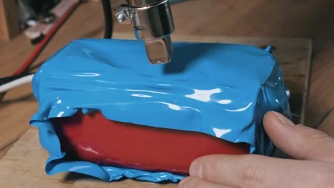 Applying Blue Heat Shrink To Lithium Battery Pack With Heat Gun Stock Footage 329683025