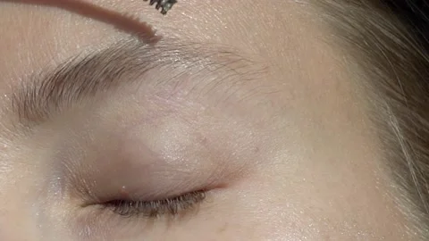 Applying brow mascara on brows close up Video stock 132688494