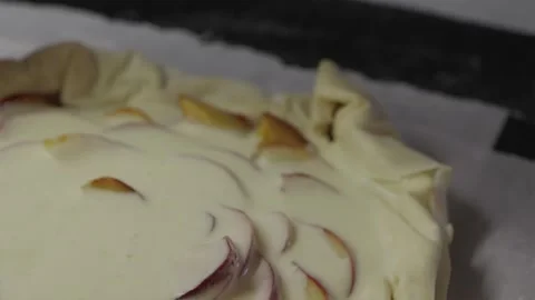 Applying butter wash on folded edges of galette before baking Stock Footage 336848357