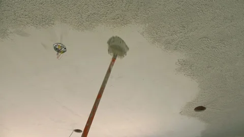 Applying ceiling texture at a home construction site Stock Footage 104465410
