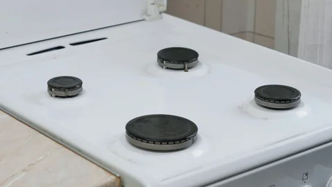 Applying the cleaning agent to the surface of the stove and cleaning it Stock Footage 121338352