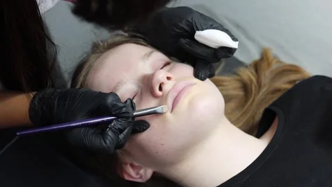 Applying concealer before permanent lip tattoo Stock Footage 316430307