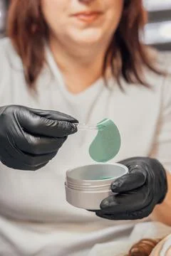 Applying Cooling Eye Patch with Precision Stock Photos