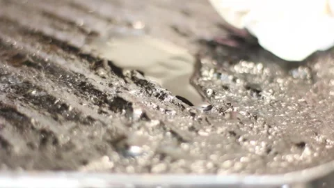 Applying corn oil and spreading it with a piece of cotton cloth on the surfac Stock Footage 305806271