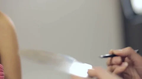 Applying cosmetics on lips of young woman. Panning Stock Footage 72146853