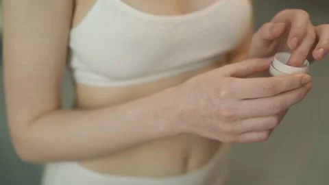 Applying the cream to the skin of the hand. Squeezing the liquid out of the tube Stock-Footage 147666746