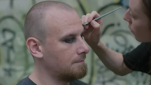 Applying Dark Eye Makeup to a Man Video stock 330921408