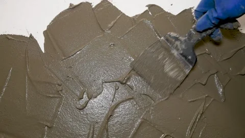 Applying decorative plaster to a wall with a spatula. Stock Footage 340522665