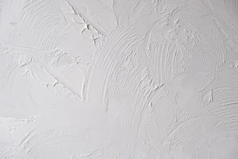 Applying decorative putty. White abstract texture of surface covered with putty Stock Photos