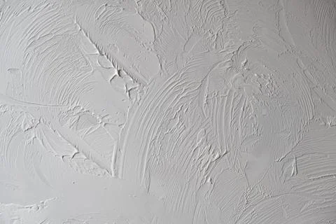 Applying decorative putty. White abstract texture of surface covered with putty Stock Photos