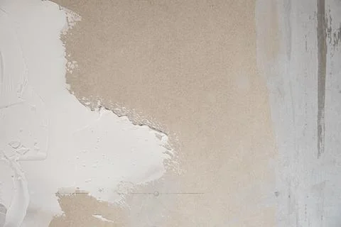 Applying decorative putty. White abstract texture of surface covered with putty Stock Photos