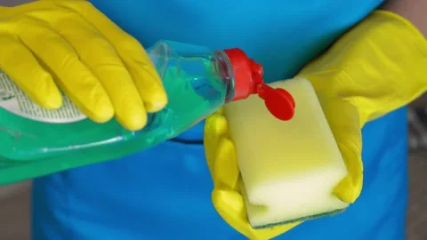 Applying detergent to sponge from bottle of household chemicals. Stock Footage 231331088