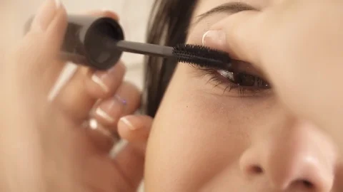 Applying eye mascara to the woman's eye closeup Stock Footage 75382823