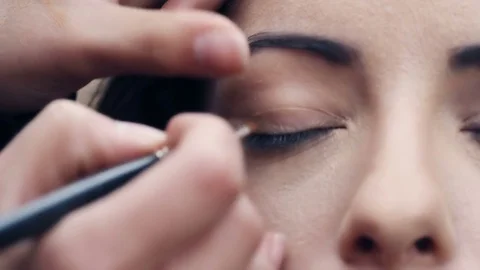 Applying  eye shadow On beautiful woman's Eyes Stock Footage 83422163