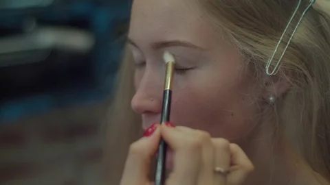 Applying eye shadows with makeup brush close-up 4k professional artist  Stock Footage 71707360