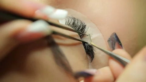 Applying the false eyelashes to model Stock Footage 74487137