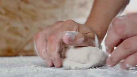 Applying flour on dough. 4K Stock Footage 153757809