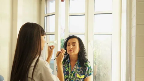 Applying Foundation to face Stock Footage 98482115